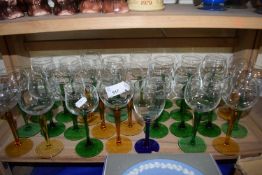 Quantity of modern wine glasses with coloured stems