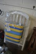 White folding garden chair with striped padded seating