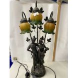 Modern three branch table lamp with figural base