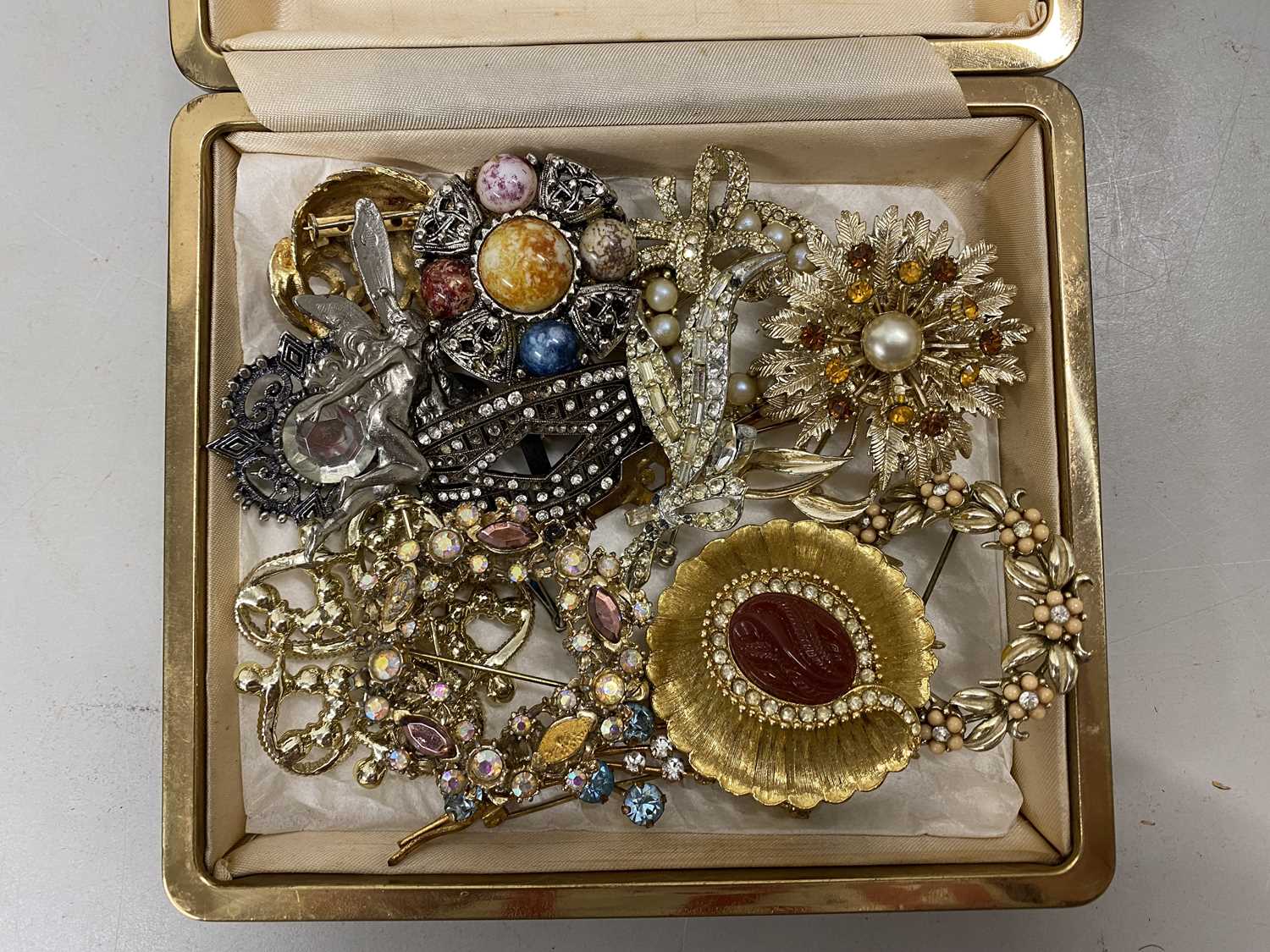 Case of various costume brooches