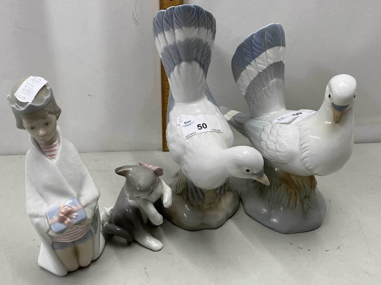 Lladro model of a cat and mouse together with a further Lladro model of a figure praying and two