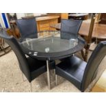 Modern circular glass top dining table and four accompanying black upholstered chairs