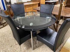 Modern circular glass top dining table and four accompanying black upholstered chairs