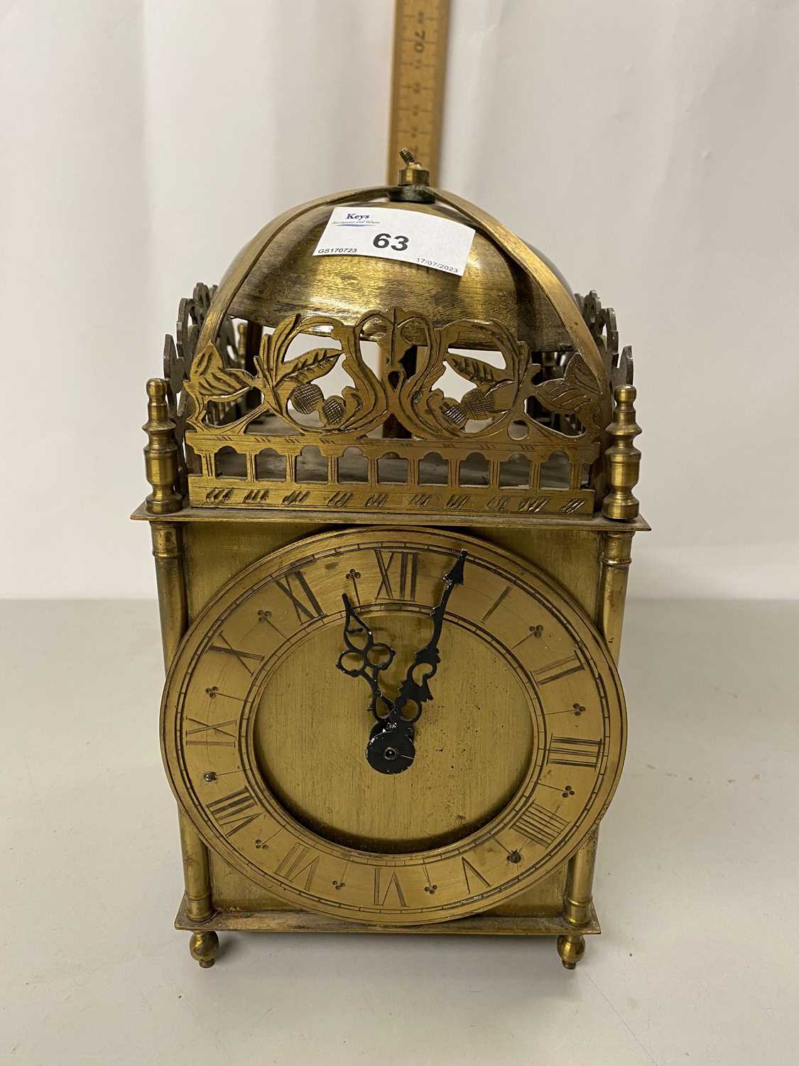 A brass lantern style clock with battery movement