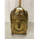 A brass lantern style clock with battery movement