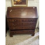 A Georgian mahogany bureau of typical form, the full front opening to an interior with small drawers