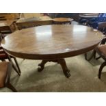 Victorian mahogany pedestal dining table with oval top raised on three scroll legs