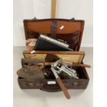 Small case containing various mixed items including flat irons, horse brass, cased butter knives