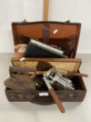 Small case containing various mixed items including flat irons, horse brass, cased butter knives