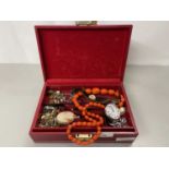 Red jewellery box containing various costume jewellery, pocket watch, wristwatch etc