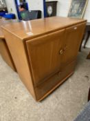 Ercol light elm television cabinet with two doors and drop down front, later internal