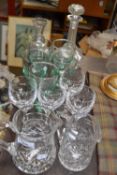 Mixed lot of glass ware to include cut glass water jugs, drinking glasses, decanters etc