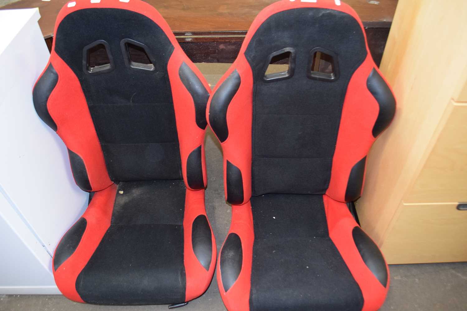 Pair of red and black car seats