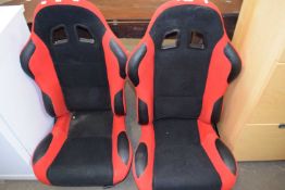 Pair of red and black car seats