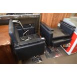 Pair of black hairdressers/barbers chairs