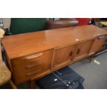 Mid 20th Century teak sideboard with central cupboards and drawers and drop down flap to either