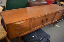 Mid 20th Century teak sideboard with central cupboards and drawers and drop down flap to either