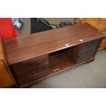 TV cabinet with three drawers to one side, glazed cupboard to other and hollow central cubby, approx