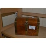 Wooden musical jewellery box in the shape of a treasure chest with brass bindings