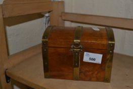 Wooden musical jewellery box in the shape of a treasure chest with brass bindings