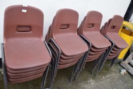 Quantity of brown plastic stacking chairs, approx 24