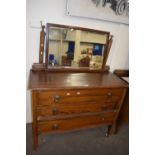 An oak three drawer dressing table
