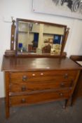 An oak three drawer dressing table