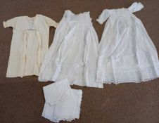 Three white cotton christening gowns, another childs cream dress with floral embroidery and 3