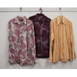 Three gentleman's 1970's / 80's patterned shirts, to include a brown and orange shirt with winged