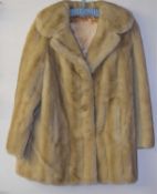 A lady's cream faux fur jacket