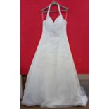 A cream satin halterneck wedding gown, with beaded bodice, chiffon overaly and beaded hemline and