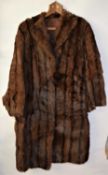 A lady's brown fur coat