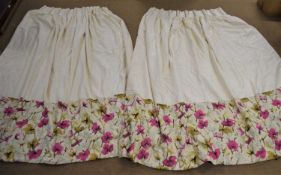 A pair of cream and pink floral curtains, in all over cream with a deep pink floral border, pinch