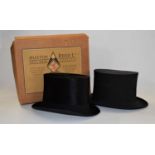 A black silk top hat by Dunn & Co, London, boxed by Austin Reed, together with a collapsible top hat