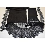 A black embroidered scarf, either end embroidered with flowers and scalloped motif with floral