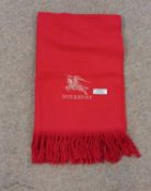 A red cashmere scarf by Burberry, with gold embroidered Burberry logo, 61cm wide x 174cm long,