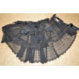A Victorian black lace shawl, the three tiered lace shawl with French jet and beaded decoration