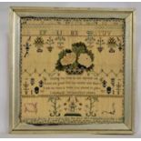 An early 19th century needlework sampler, with central cross stitch basket of flowers, with