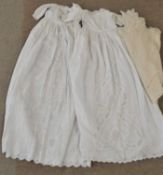Two white cotton christening gowns, both with broiderie anglaise style embroidered panels to