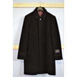 A gentleman's black wool and cashmere overcoat, single breasted three button fastening, size L,