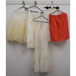 A quantity of vintage underwear to include a mid 20th century V-neck slip, two mesh underskirts, a