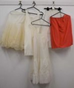 A quantity of vintage underwear to include a mid 20th century V-neck slip, two mesh underskirts, a