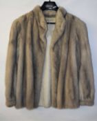 A lady's grey fur jacket, with stand up collar and cuffed sleeves, single snap fastening few marks