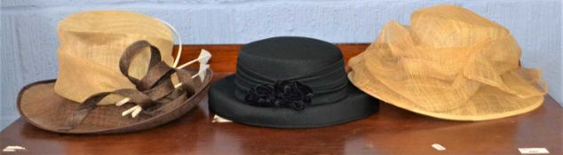 Three lady's hats to include two straw hats and a navy blue hat, (3)