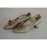 A pair of 19th/20th century pale green satin lady's shoes, with pink floral decoration
