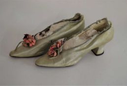 A pair of 19th/20th century pale green satin lady's shoes, with pink floral decoration