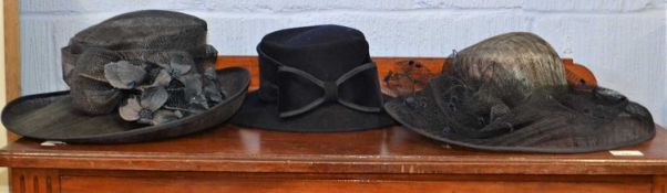 Three hats to include a navy blue wool felt hat and two navy blue straw hats, (3)