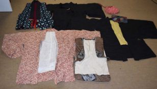 A quantity of Japanese clothing to include a black and yellow reversible kimono jacket, a black