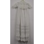 A white cotton christening gown, c.1860-70, with lace neckline and frill, lace and embroidered