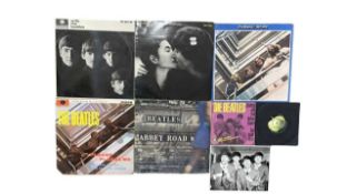 A collection of Beatles 12" vinyl LPs and 7" singles, to include: - With the Beatles - The